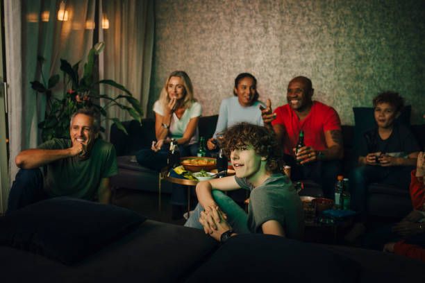 Friends and family watching live sports on IPTV at night