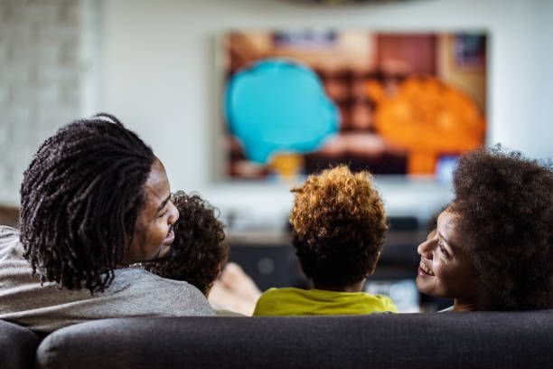 Family watching IPTV Smarters Player on their living room TV together